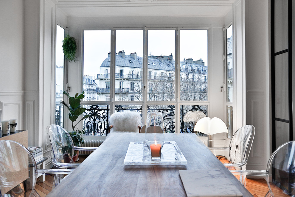 This is an example of a mid-sized modern open plan dining in Paris with white walls.