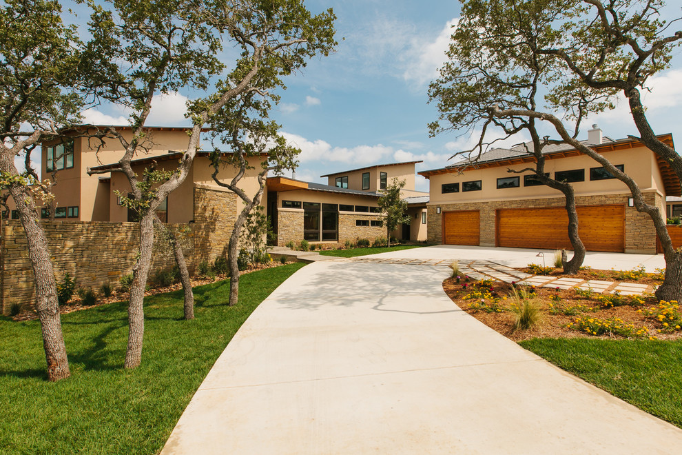 Inspiration for an expansive contemporary beige exterior in Austin with stone veneer.