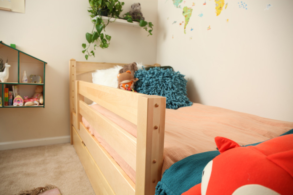 Example of a small transitional gender-neutral kids' room design in Other with green walls