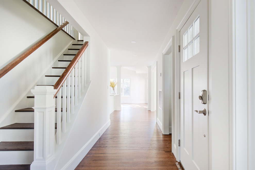 Example of a mid-sized transitional medium tone wood floor and brown floor hallway design with white walls
