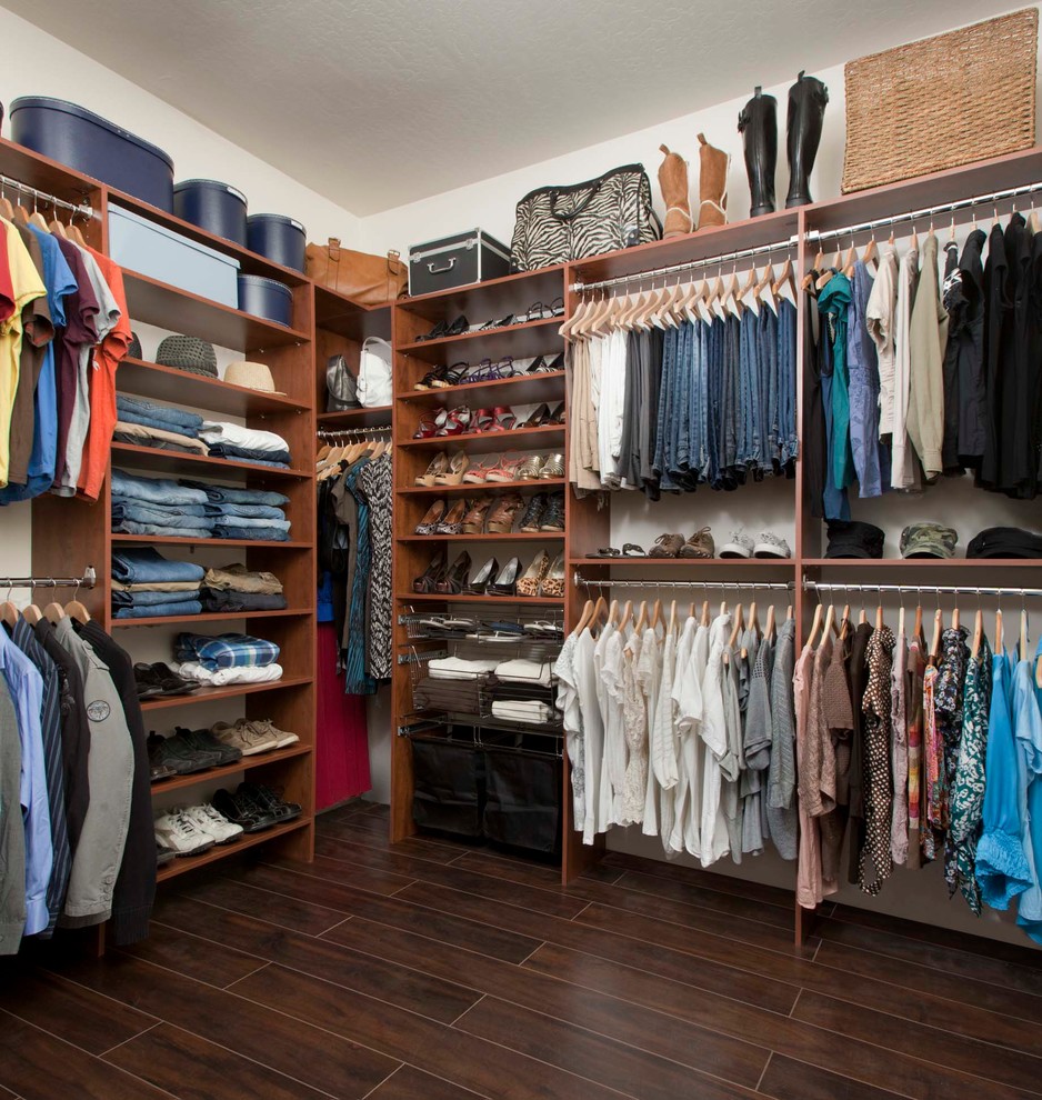 Inspiration for a mid-sized transitional gender-neutral walk-in wardrobe in Other with flat-panel cabinets, medium wood cabinets and porcelain floors.