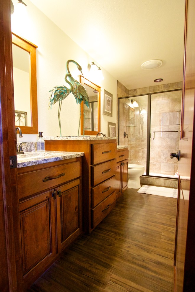Example of a mid-sized kids' bathroom design with an undermount sink, raised-panel cabinets and granite countertops