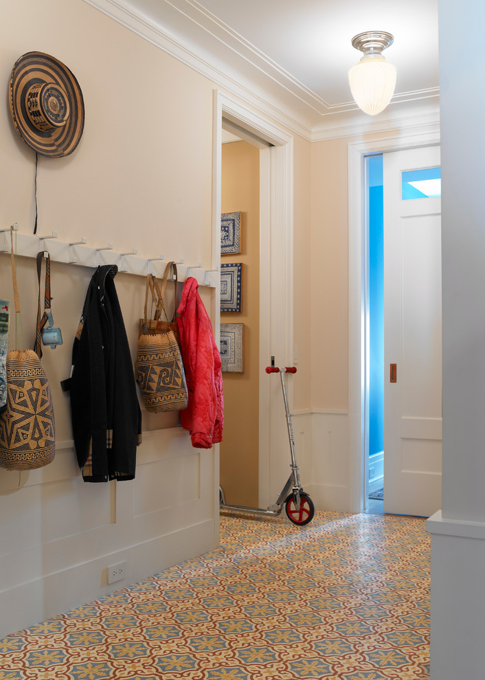 Photo of a transitional entryway in New York with ceramic floors and multi-coloured floor.