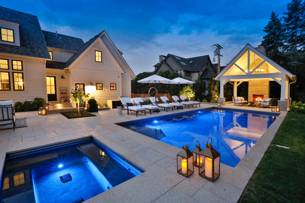 Mid-sized elegant backyard stone and rectangular lap hot tub photo in Chicago
