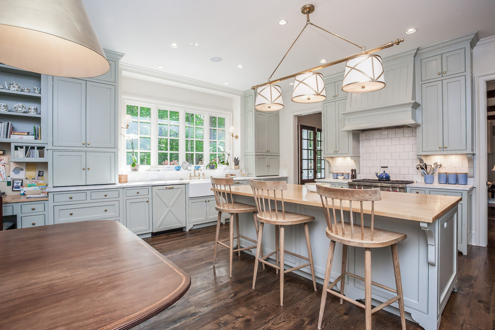 Inspiration for a large country u-shaped eat-in kitchen in Atlanta with a farmhouse sink, beaded inset cabinets, grey cabinets, marble benchtops, white splashback, subway tile splashback, with island and dark hardwood floors.