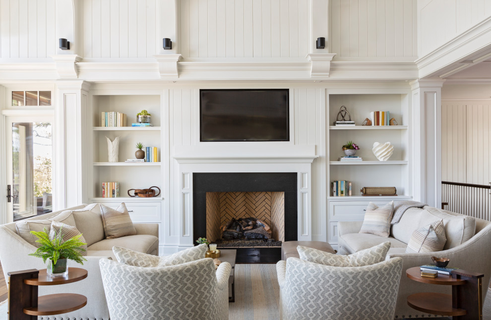 Inspiration for a beach style open concept living room in Charleston with white walls, a standard fireplace and a wall-mounted tv.