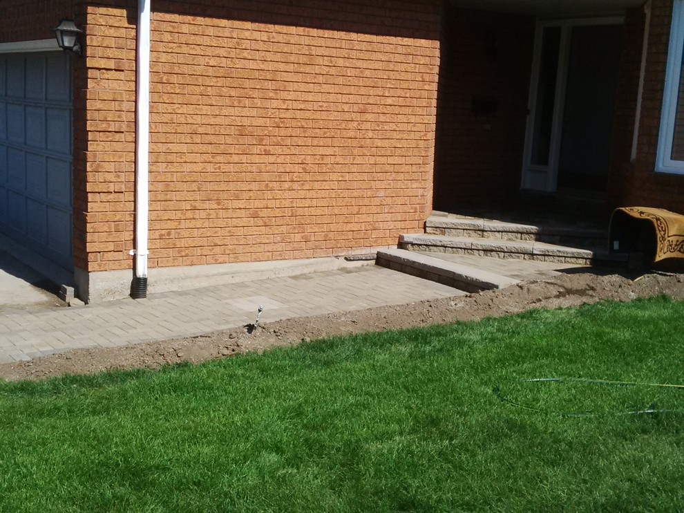 Photo of a mid-sized partial sun front yard landscaping in Toronto.