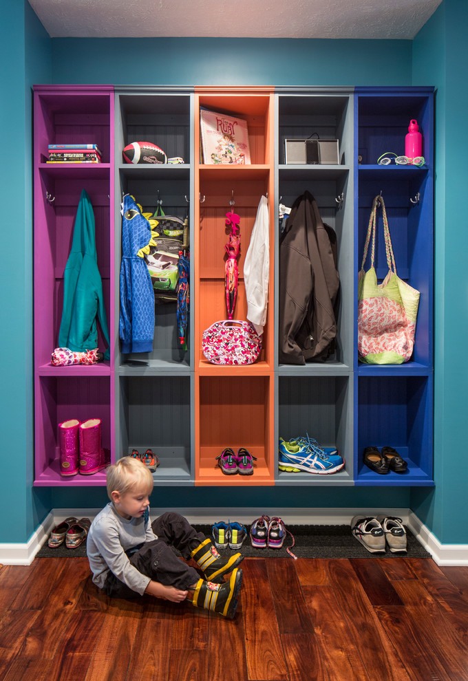 Design ideas for a traditional mudroom in Chicago with blue walls and dark hardwood floors.