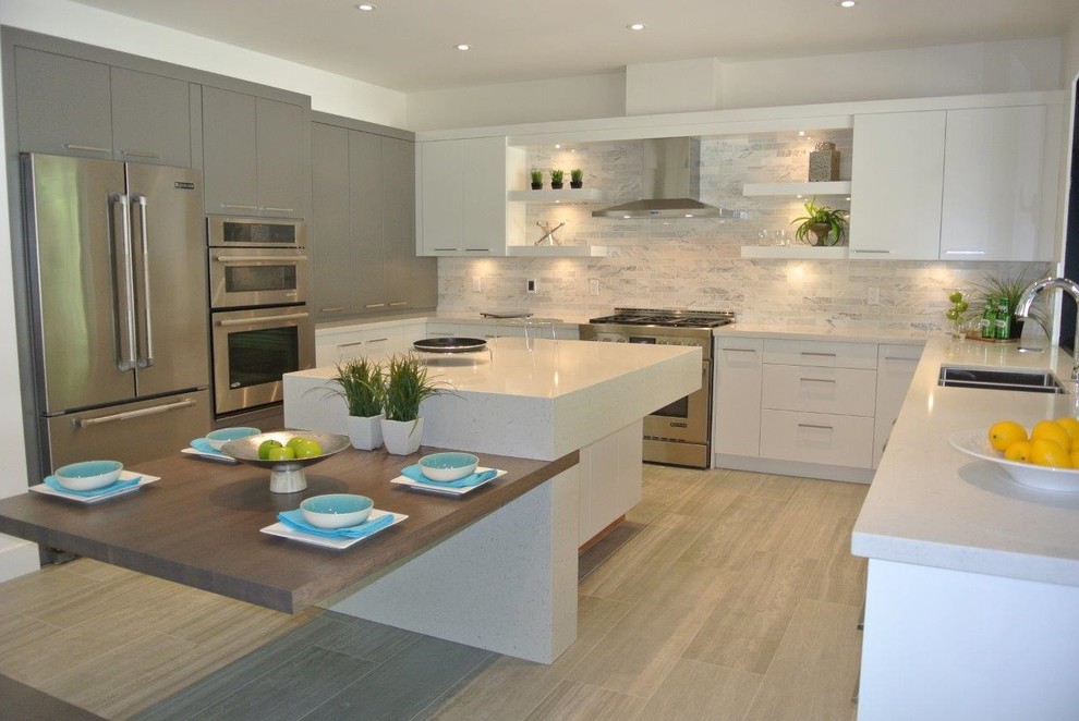 This is an example of a mid-sized contemporary u-shaped eat-in kitchen in Vancouver with flat-panel cabinets, white cabinets, quartz benchtops and with island.