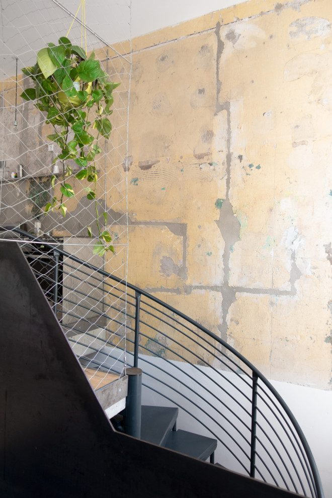 Mid-sized contemporary metal curved staircase in Berlin with metal risers and metal railing.