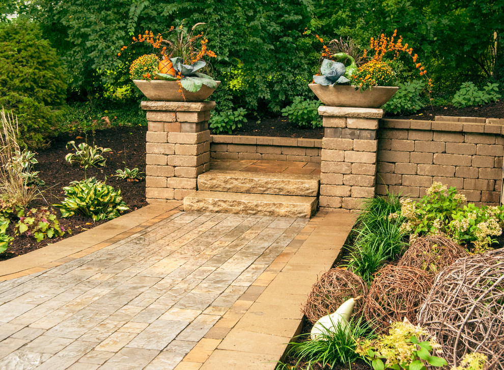 This is an example of a transitional shade backyard brick landscaping in St Louis for fall.