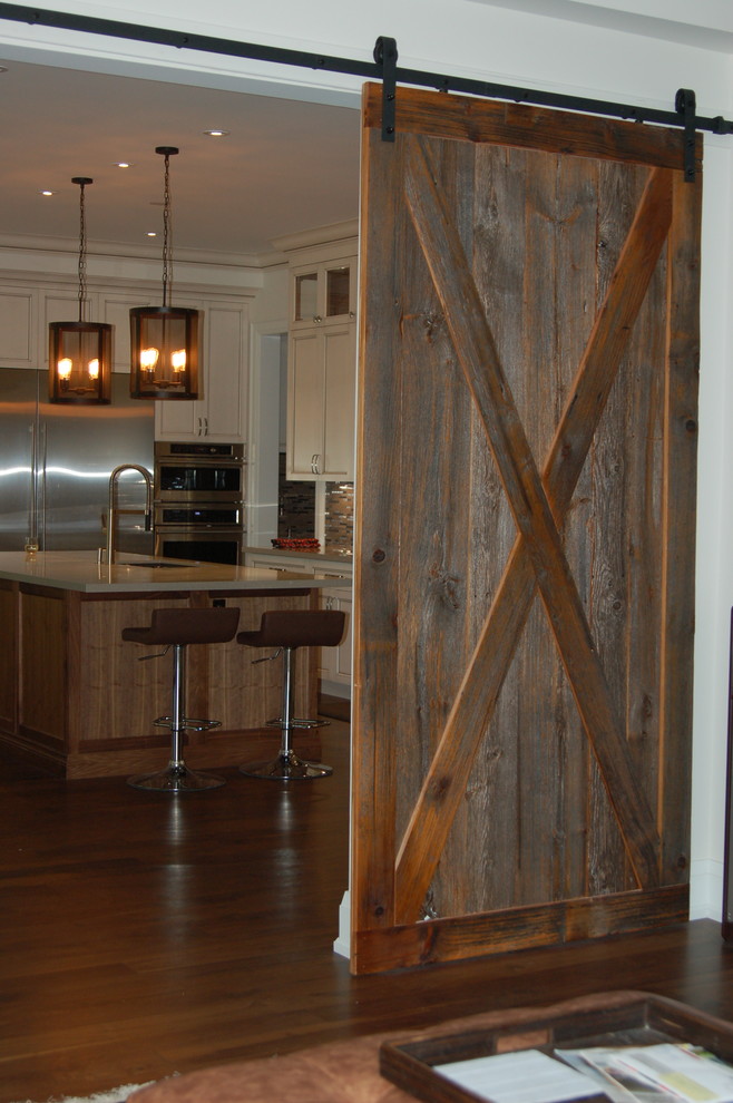 Inspiration for a large transitional l-shaped dark wood floor and brown floor open concept kitchen remodel in Toronto with an undermount sink, beaded inset cabinets, white cabinets, quartz countertops, metallic backsplash, matchstick tile backsplash, stainless steel appliances, an island and beige countertops