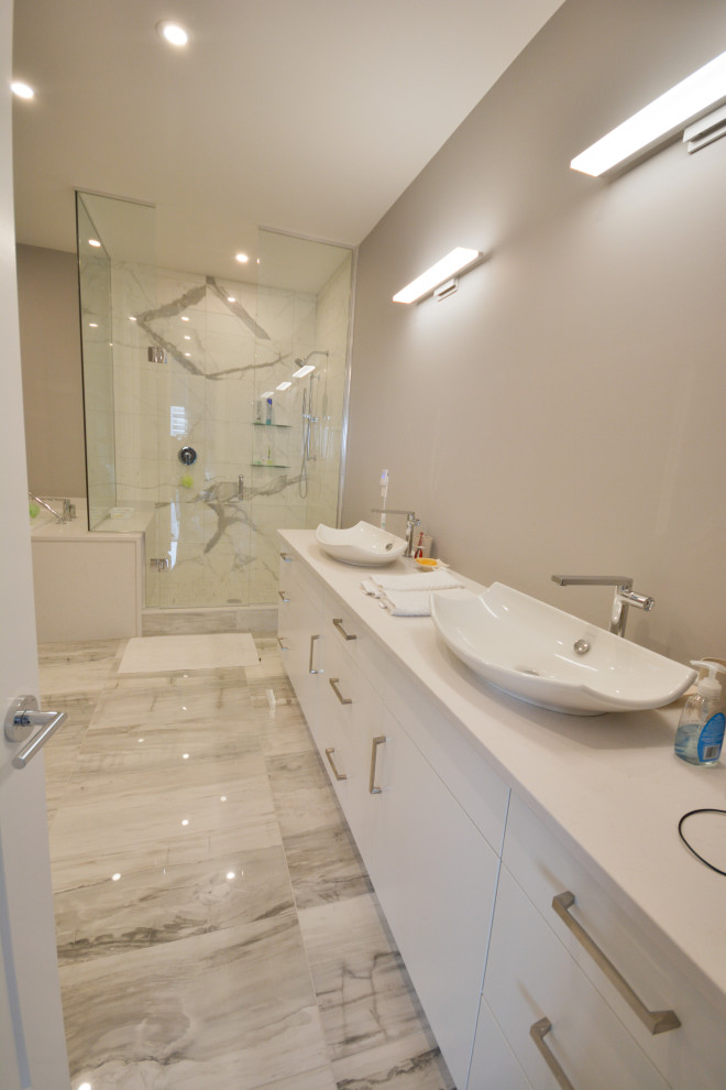 Bathroom - large transitional master double-sink bathroom idea in Toronto with flat-panel cabinets, white cabinets, quartz countertops, white countertops and a built-in vanity