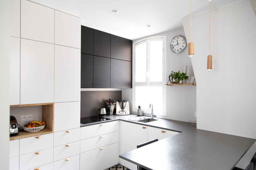 Mid-sized scandinavian u-shaped kitchen in Other with an undermount sink, flat-panel cabinets, laminate benchtops, black splashback, cement tiles, a peninsula, multi-coloured floor, black benchtop and black cabinets.