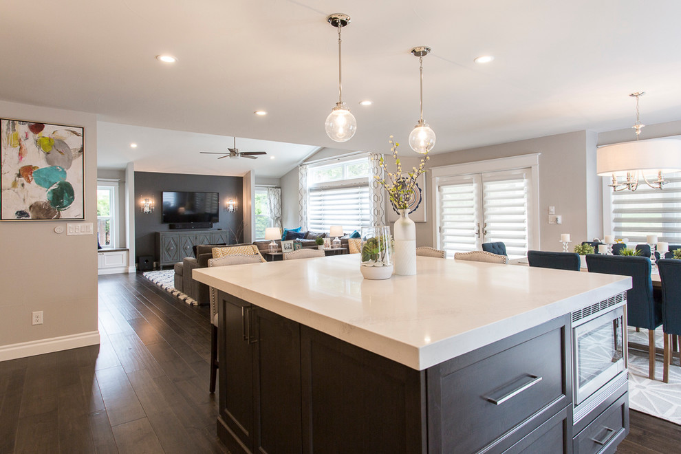 Eat-in kitchen - large transitional l-shaped medium tone wood floor and brown floor eat-in kitchen idea in Denver with a single-bowl sink, recessed-panel cabinets, white cabinets, quartz countertops, gray backsplash, ceramic backsplash, stainless steel appliances and two islands