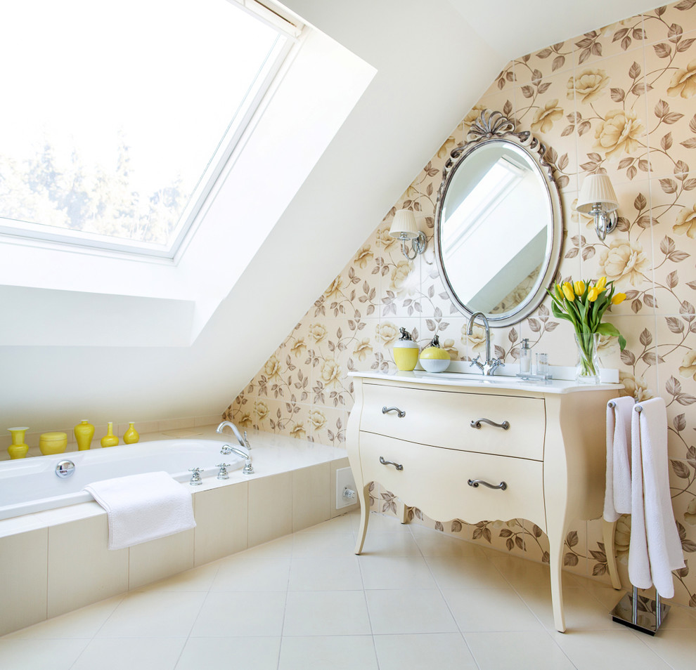 Mid-sized traditional bathroom in Munich with beige cabinets, marble benchtops, a drop-in tub, multi-coloured tile, ceramic tile, beige walls, travertine floors and flat-panel cabinets.