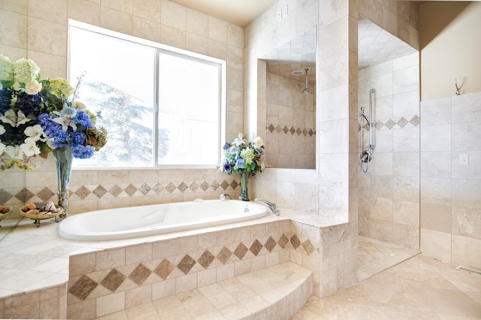 Design ideas for a large traditional master bathroom in Salt Lake City with furniture-like cabinets, dark wood cabinets, a drop-in tub, a curbless shower, a bidet, beige tile, travertine, beige walls, travertine floors, a vessel sink, granite benchtops, beige floor, an open shower and grey benchtops.