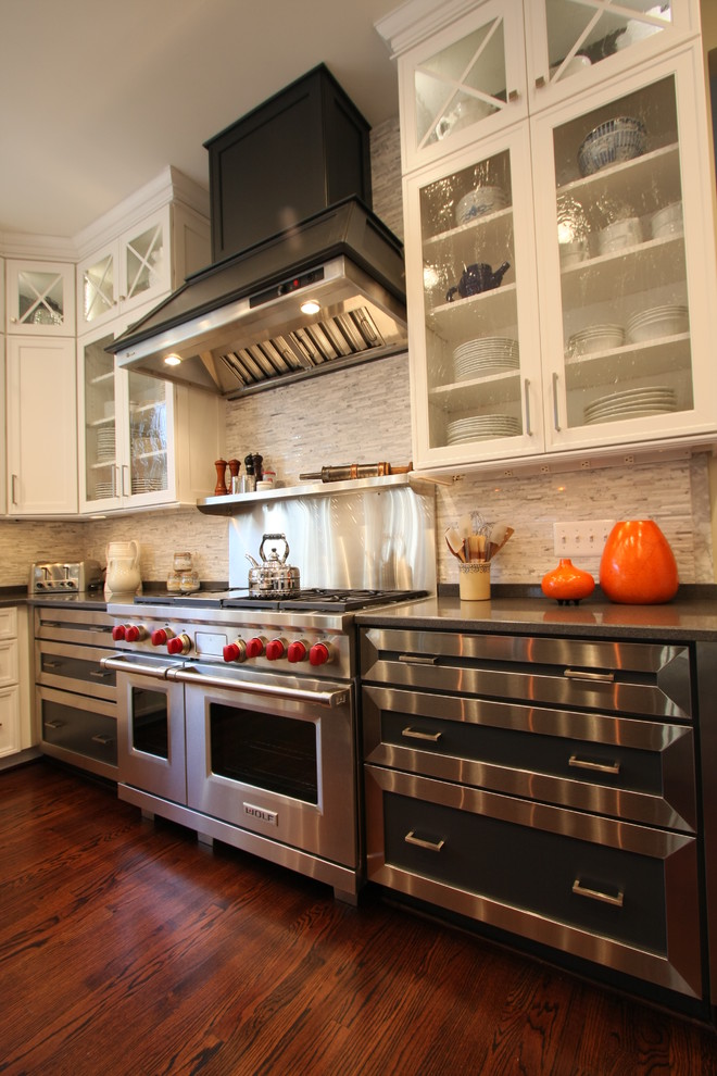 Photo of a traditional kitchen in DC Metro with glass-front cabinets and stainless steel appliances.