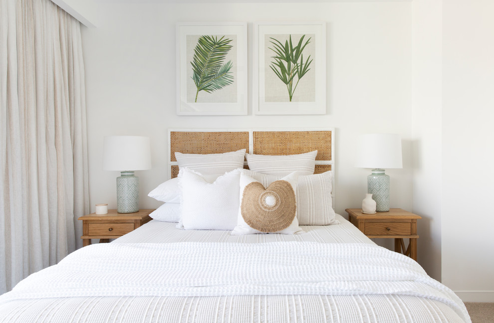 Mid-sized beach style guest bedroom in Gold Coast - Tweed with white walls, carpet and beige floor.