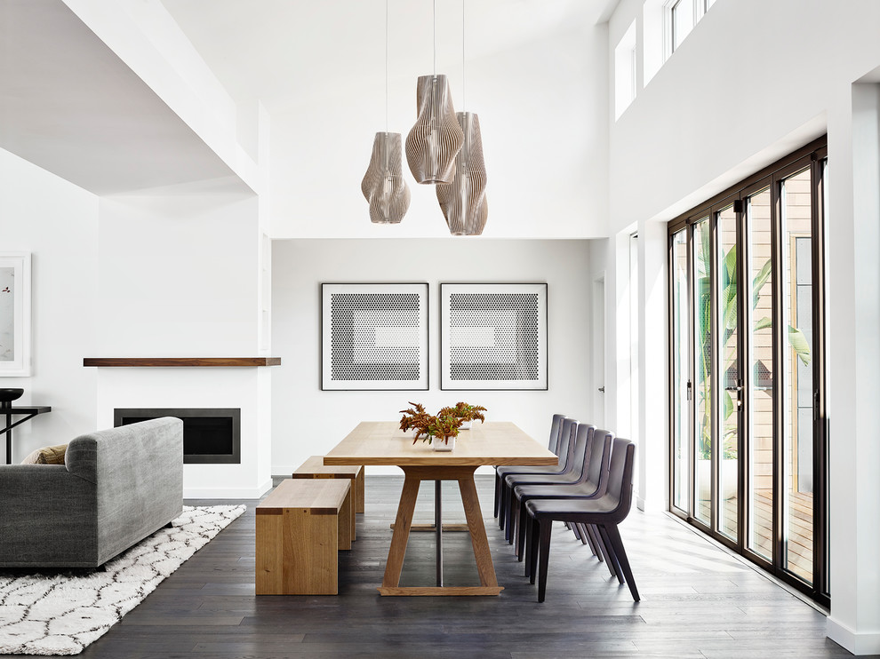 Design ideas for a contemporary dining room in San Francisco with white walls, dark hardwood floors and brown floor.