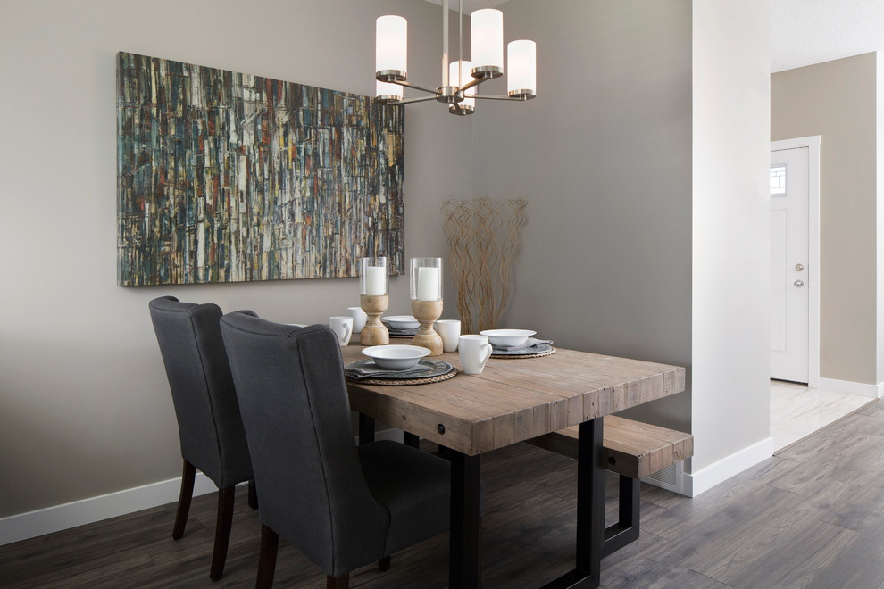 Design ideas for a mid-sized transitional open plan dining in Calgary with grey walls and light hardwood floors.
