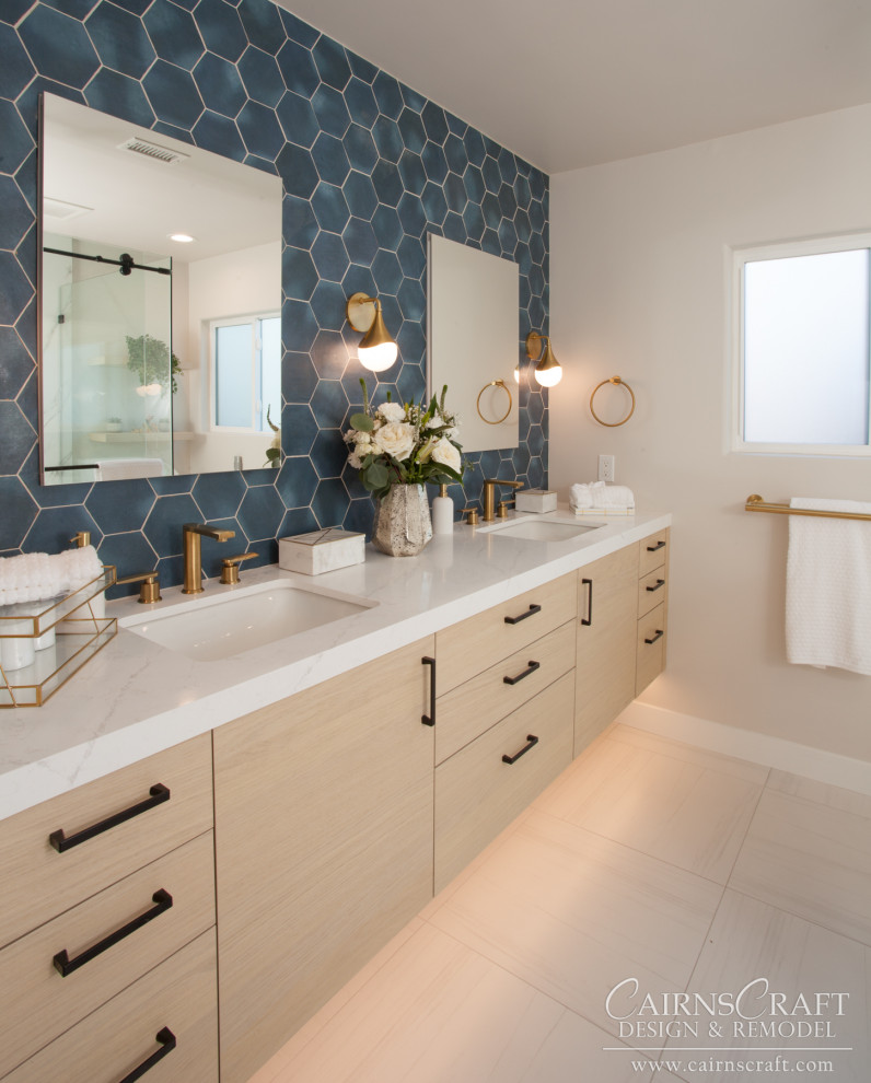 Photo of a mid-sized contemporary master bathroom in San Diego with flat-panel cabinets, light wood cabinets, a corner shower, a one-piece toilet, blue tile, ceramic tile, beige walls, porcelain floors, an undermount sink, engineered quartz benchtops, beige floor, a sliding shower screen, white benchtops, a shower seat, a double vanity and a floating vanity.