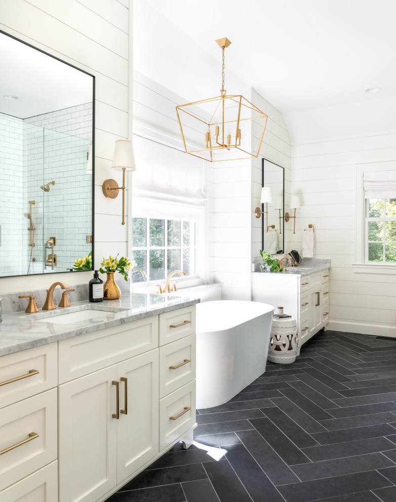 Design ideas for a large transitional master bathroom in Nashville with shaker cabinets, white cabinets, a freestanding tub, a curbless shower, a two-piece toilet, white tile, subway tile, white walls, slate floors, an undermount sink, marble benchtops, black floor, a hinged shower door, white benchtops, a niche, a single vanity, a built-in vanity, vaulted and planked wall panelling.