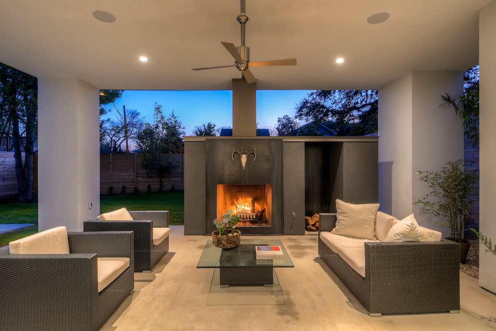Inspiration for a mid-sized contemporary backyard patio in Austin with a fire feature, concrete slab and a pergola.