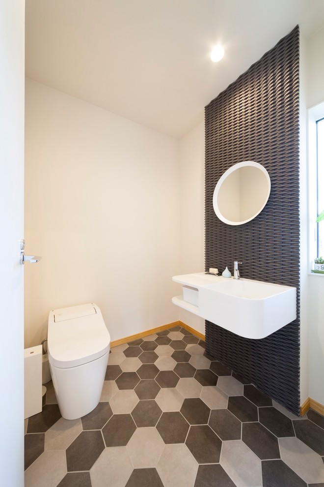 This is an example of a modern powder room in Other with white walls.