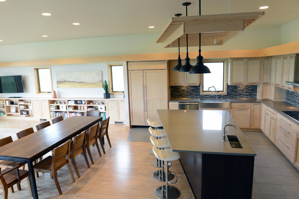 This is an example of a mid-sized contemporary l-shaped open plan kitchen in Other with shaker cabinets, stainless steel appliances and with island.