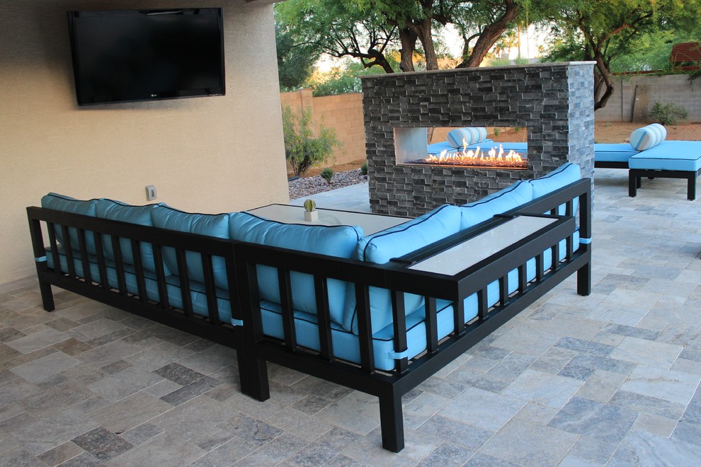 Design ideas for a large transitional backyard patio in Phoenix with with fireplace, tile and a pergola.