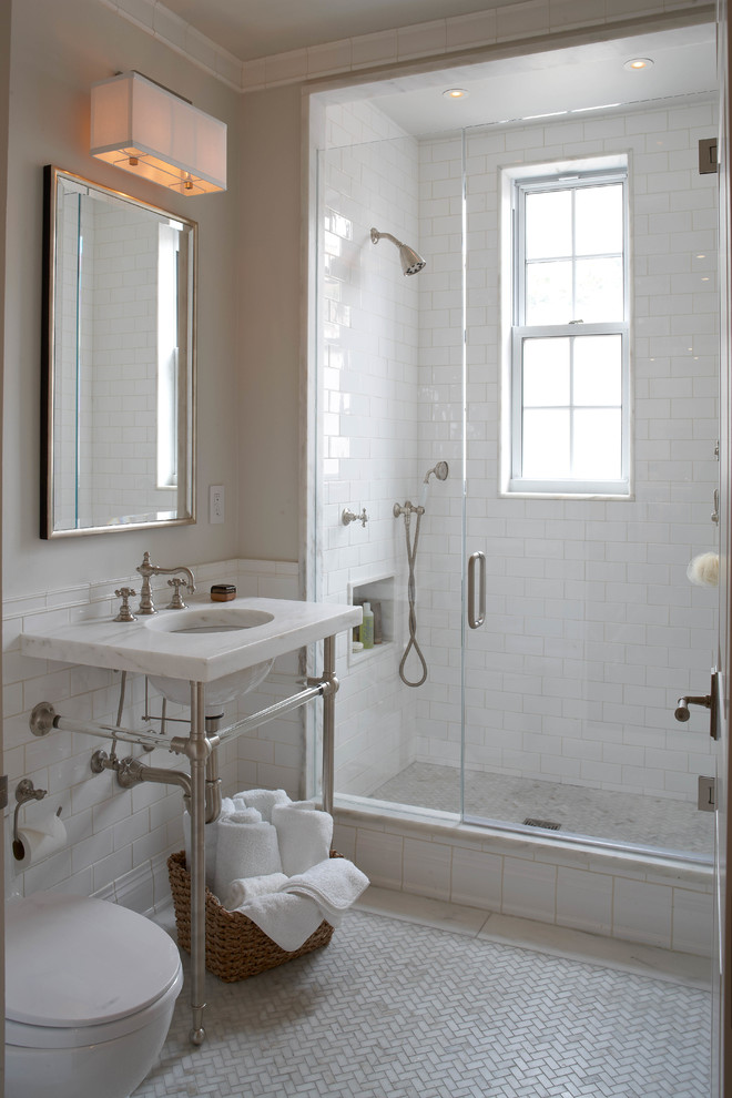 Photo of a transitional 3/4 bathroom in New York with a console sink, an alcove shower, a one-piece toilet, white tile, subway tile, beige walls and mosaic tile floors.