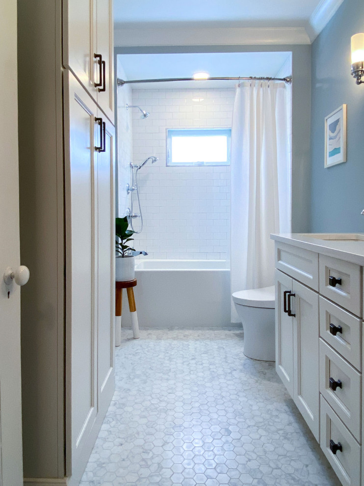Design ideas for a traditional ensuite bathroom in Boston with shaker cabinets, white cabinets, an alcove bath, a shower/bath combination, a bidet, white tiles, metro tiles, blue walls, mosaic tile flooring, a submerged sink, engineered stone worktops, grey floors, a shower curtain, white worktops, a wall niche, double sinks and a built in vanity unit.