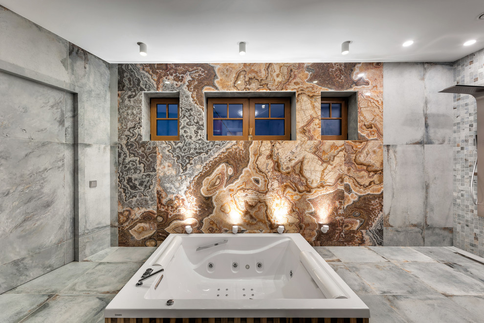 Expansive contemporary bathroom in Saint Petersburg with a hot tub, an open shower, multi-coloured tile, stone slab, multi-coloured walls, porcelain floors, with a sauna, grey floor and an open shower.