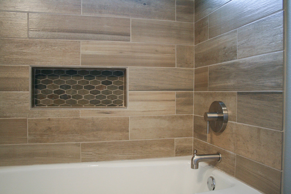 Minimalist gray tile and stone tile bathroom photo in Austin with raised-panel cabinets, medium tone wood cabinets, gray walls, a vessel sink and soapstone countertops