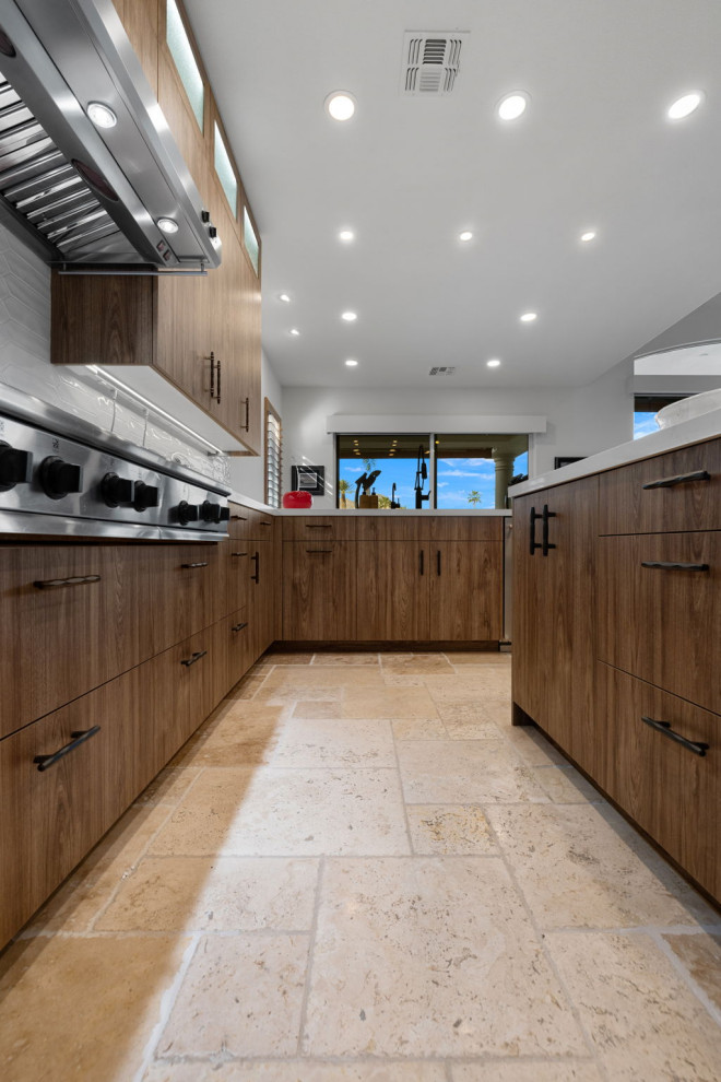 Enclosed kitchen - rustic l-shaped slate floor and beige floor enclosed kitchen idea with a single-bowl sink, flat-panel cabinets, medium tone wood cabinets, quartzite countertops, white backsplash, glass sheet backsplash, stainless steel appliances, a peninsula and white countertops