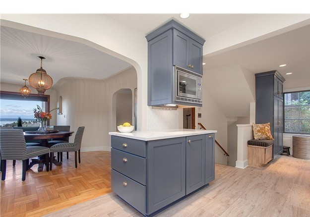 Eat-in kitchen - large transitional eat-in kitchen idea in Seattle with shaker cabinets, gray cabinets, quartz countertops, white backsplash, marble backsplash, stainless steel appliances and white countertops