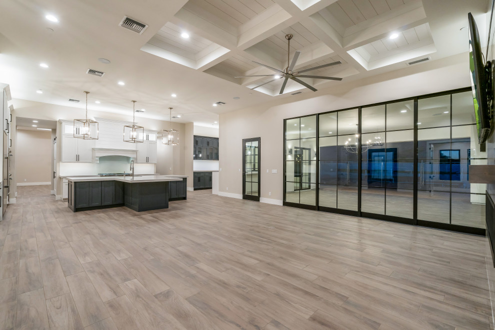 Inspiration for a large modern u-shaped coffered ceiling open concept kitchen remodel in Phoenix with white backsplash, stainless steel appliances, an island and white countertops