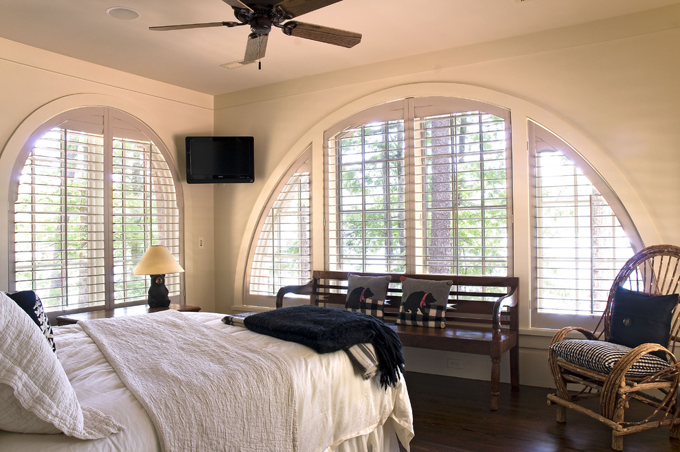 Traditional bedroom in Atlanta with beige walls and dark hardwood floors.