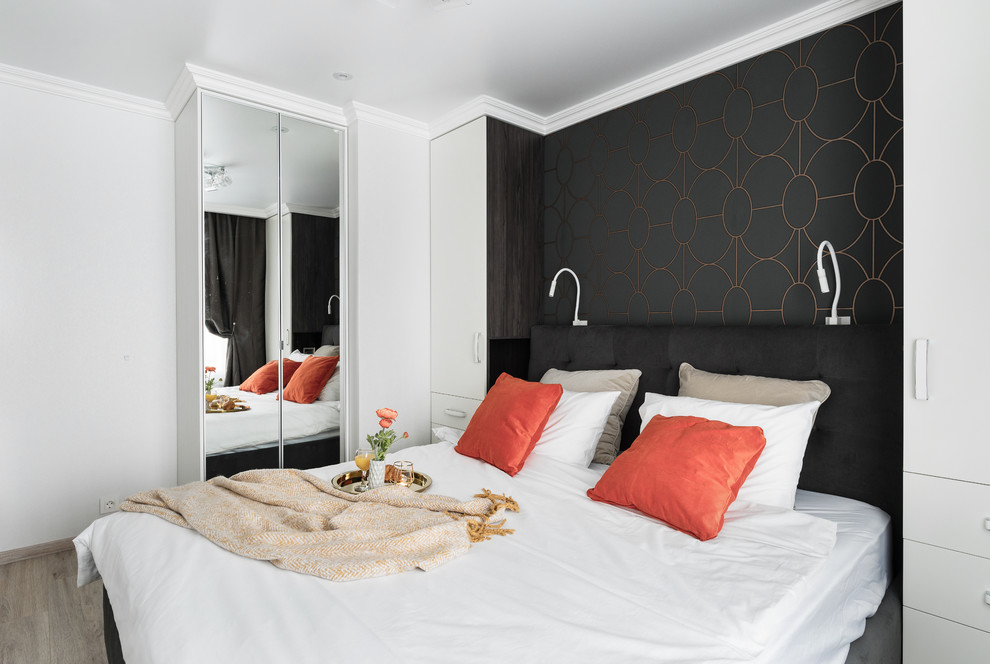Small contemporary master bedroom in Saint Petersburg with brown walls, medium hardwood floors and brown floor.
