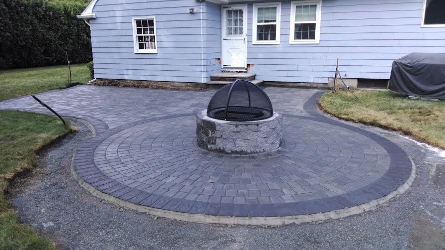 Design ideas for a large transitional backyard patio in Providence with a fire feature, concrete pavers and no cover.