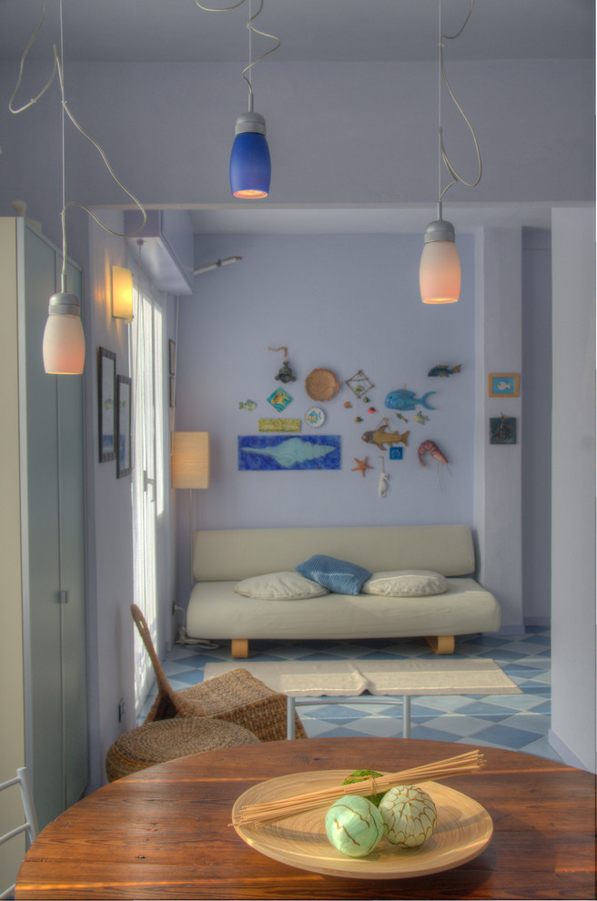 Small beach style open concept living room in Other with blue walls.