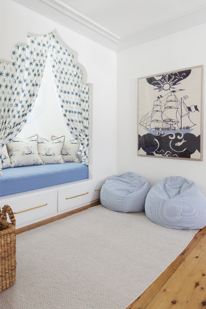 Design ideas for a beach style gender-neutral kids' playroom for kids 4-10 years old in Miami with white walls, light hardwood floors and beige floor.
