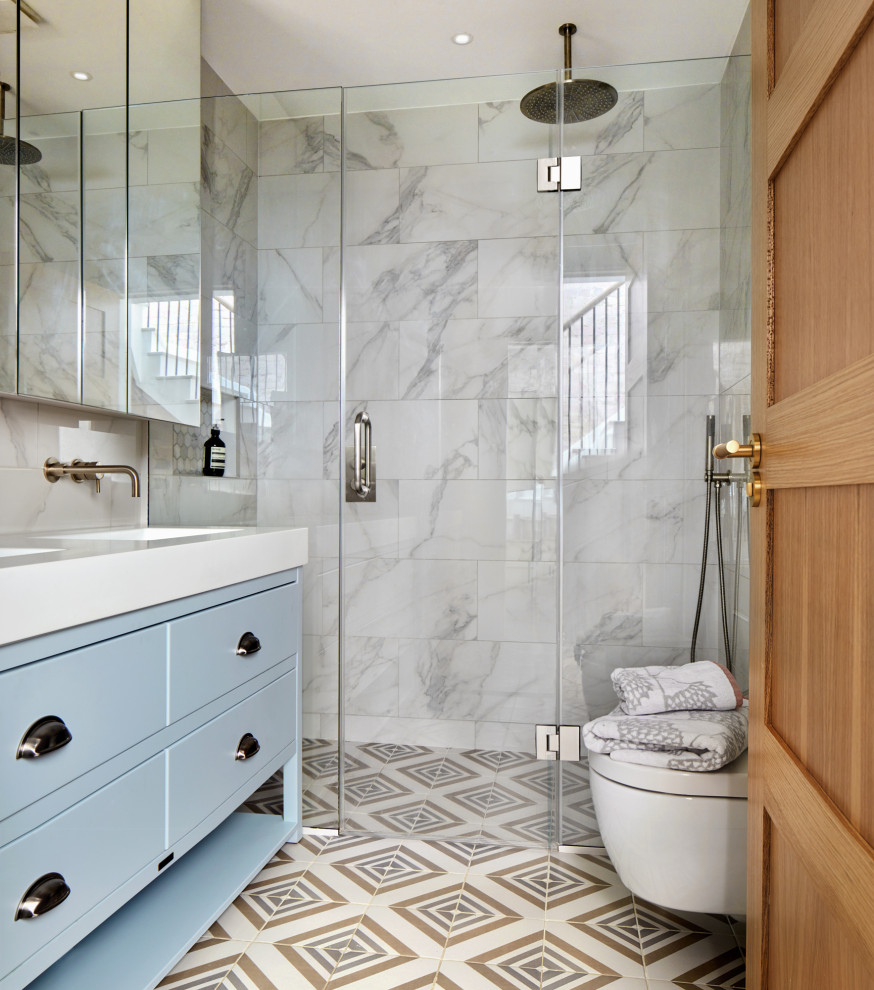 Small transitional kids bathroom in London with flat-panel cabinets, blue cabinets, an open shower, multi-coloured tile, porcelain tile, engineered quartz benchtops, a hinged shower door, white benchtops, a double vanity and a freestanding vanity.