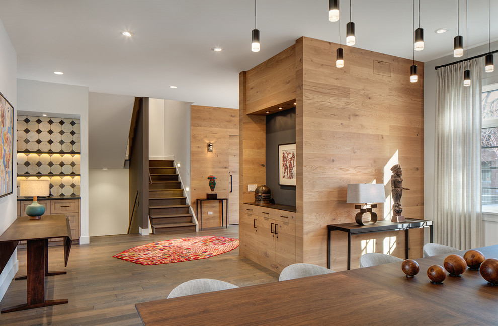 Large trendy medium tone wood floor front door photo in Chicago with white walls