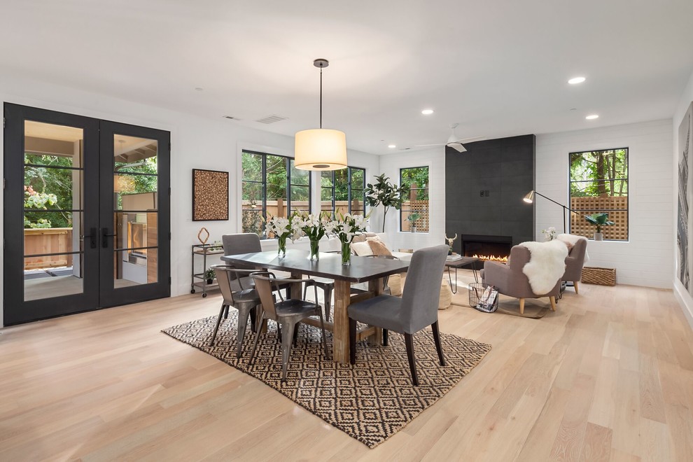 Inspiration for a mid-sized transitional open plan dining in Seattle with white walls, light hardwood floors, no fireplace and brown floor.
