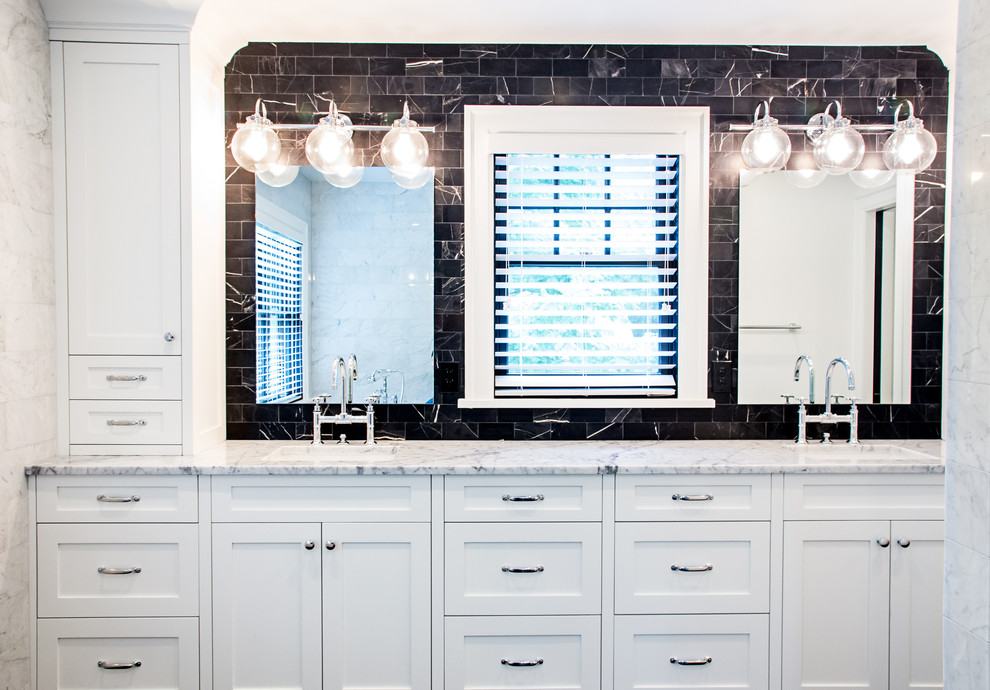 Photo of a mid-sized transitional master bathroom in Denver with an undermount sink, shaker cabinets, white cabinets, marble benchtops, an undermount tub, a double shower, a one-piece toilet, black and white tile, subway tile, white walls and marble floors.