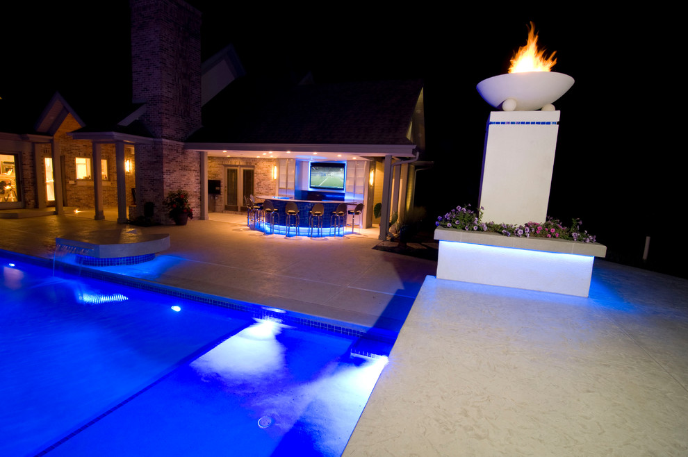 Inspiration for a large transitional backyard concrete paver and rectangular natural hot tub remodel in Cedar Rapids