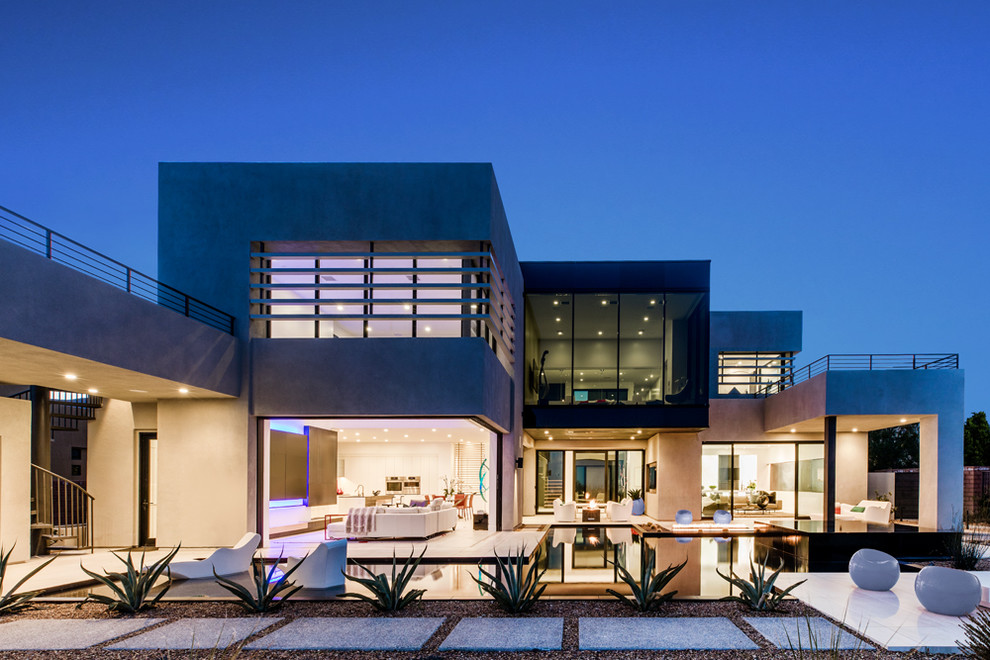 Inspiration for an expansive contemporary two-storey house exterior in Las Vegas with a flat roof.