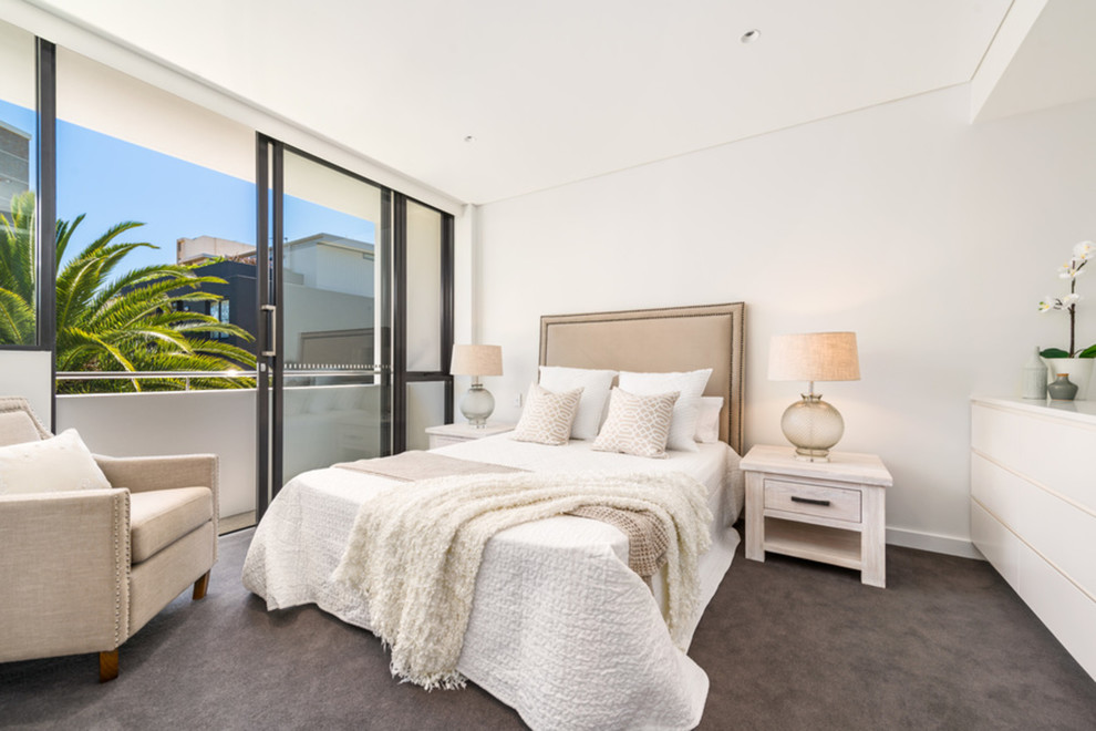 Photo of a mid-sized transitional master bedroom in Sydney with white walls, carpet and brown floor.